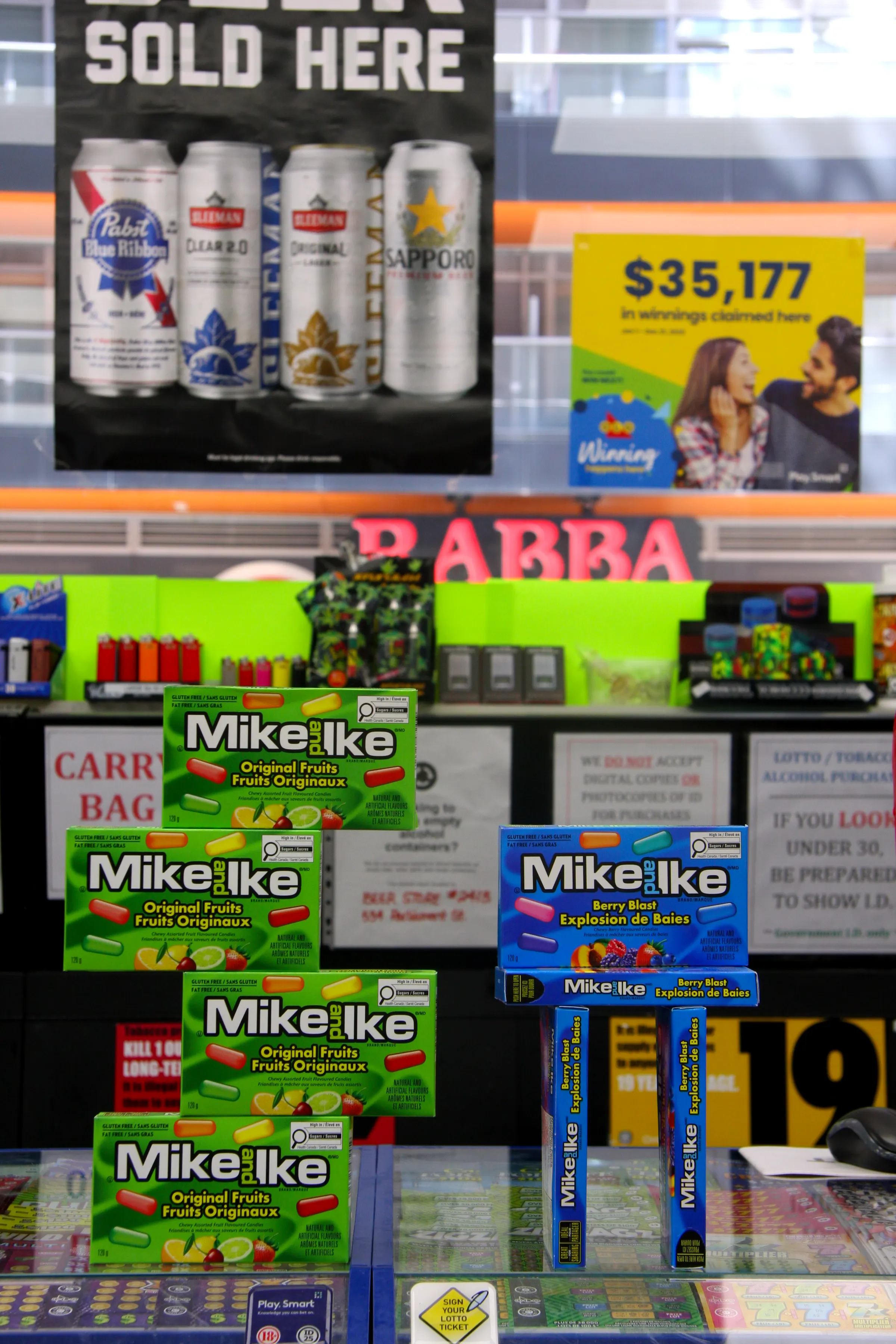 The regulated tobacco cabinet behind the counter, closed and signed as required.