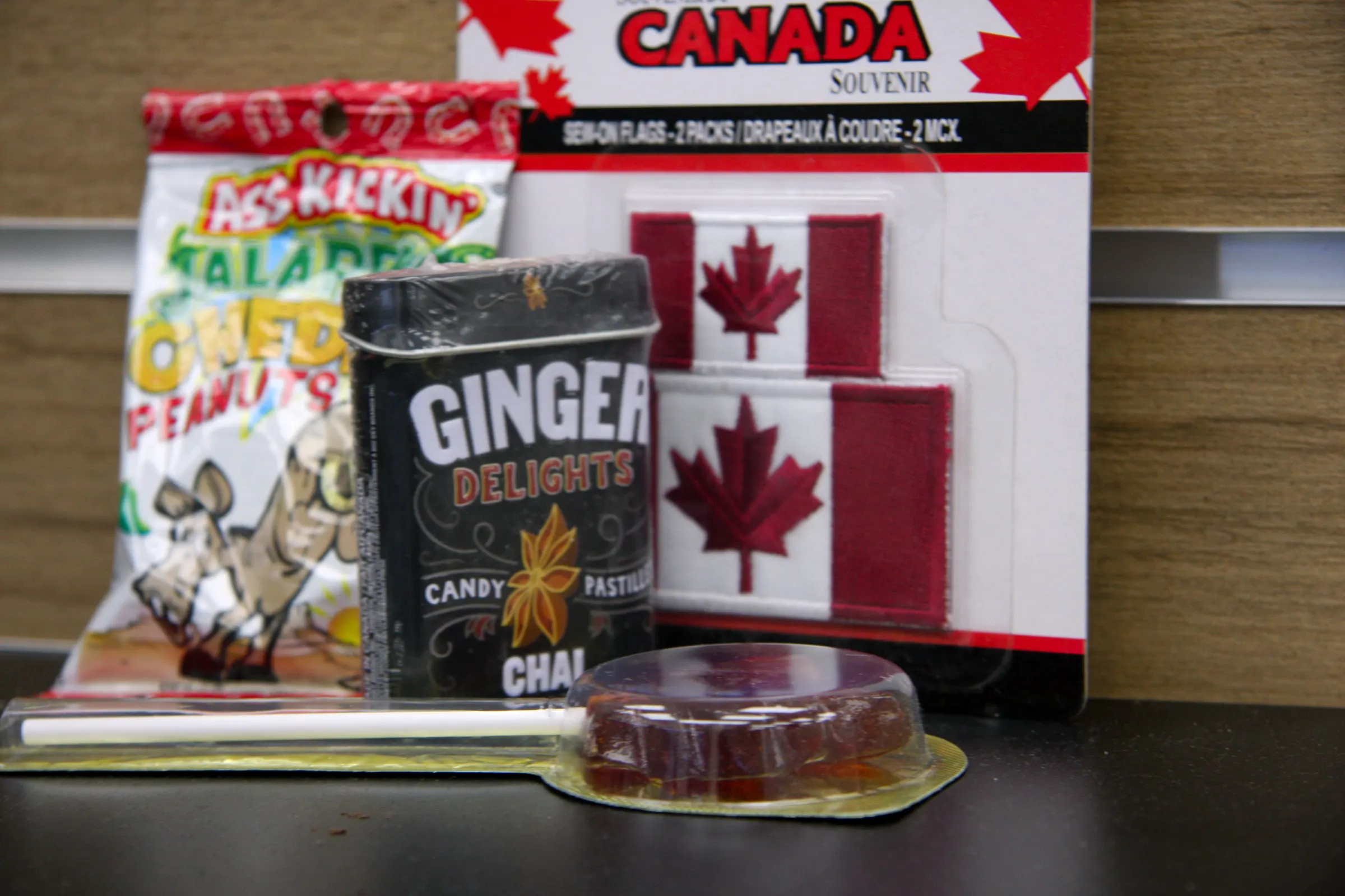 The souvenir range shot tighter — flag pack, candy tin and snack bag squared to the counter.