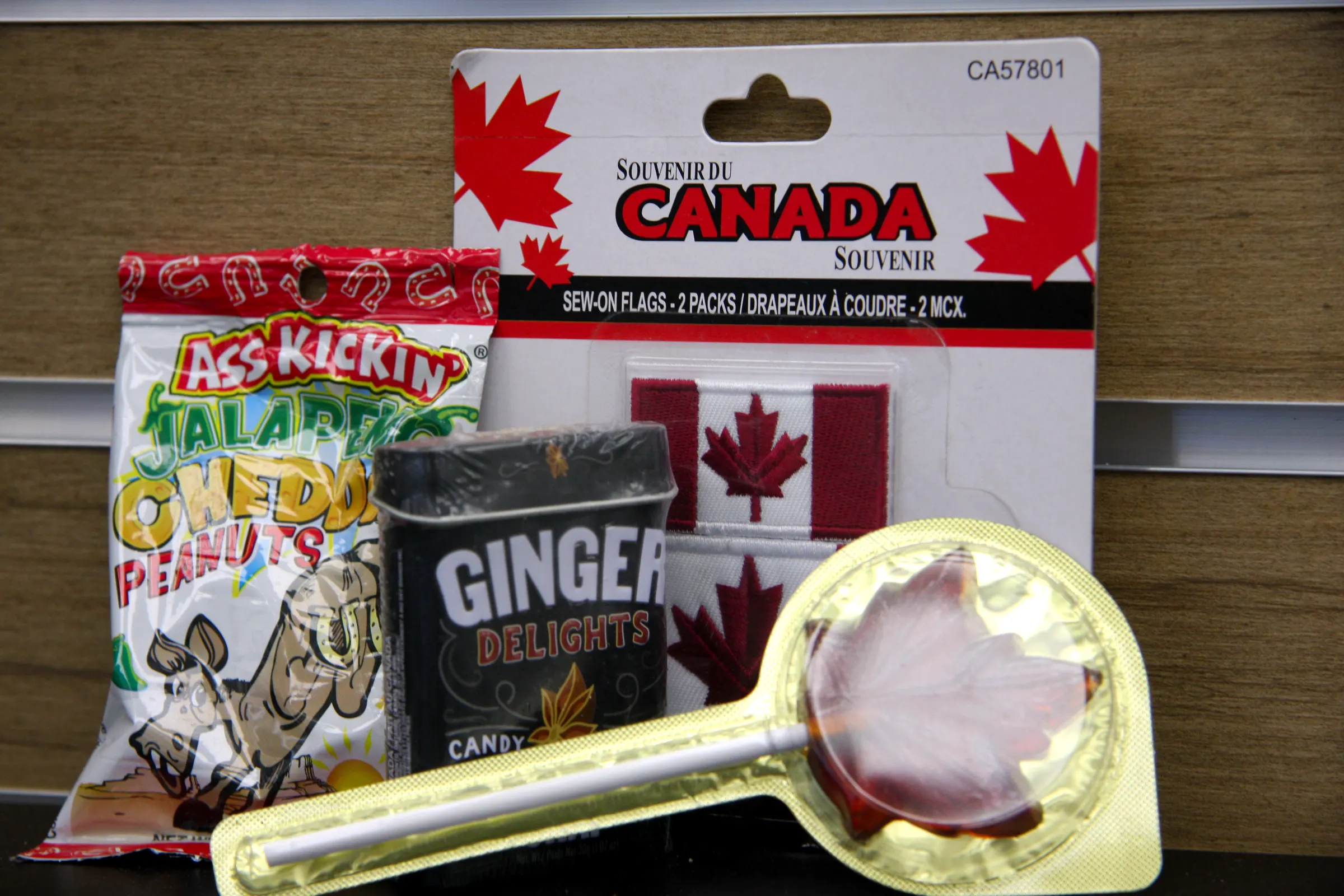 Maple leaf lollipop in the foreground with the Canada souvenir range stacked behind it.